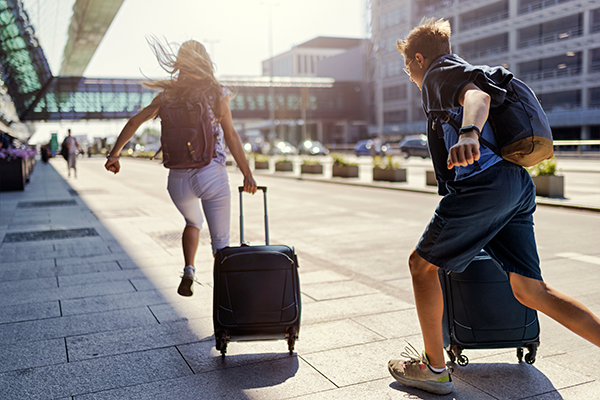 young couple running at the airport