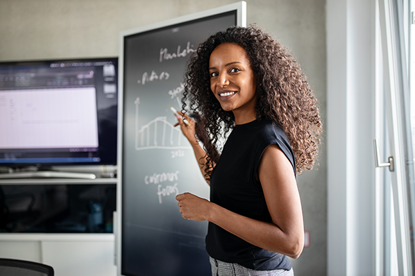 young black woman entrepreneur writing on the board