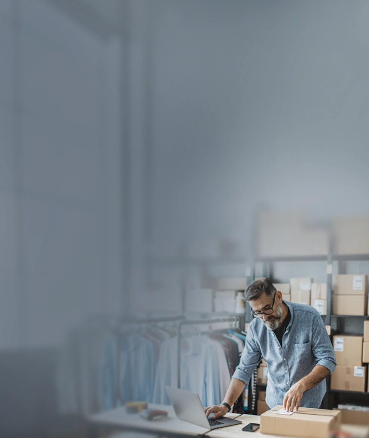A man placing a label on a retail shipping box