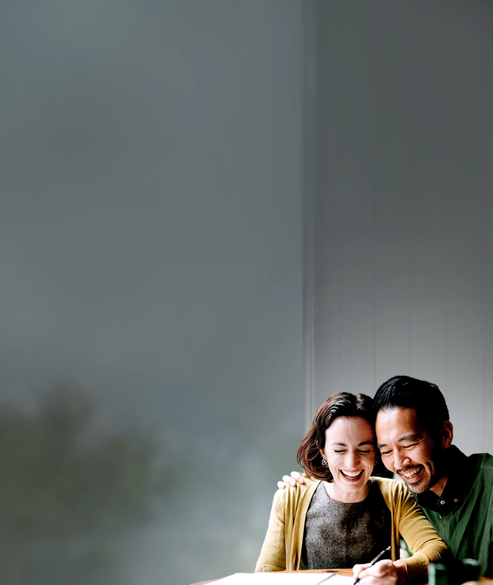 A happy man and woman writing notes in a notebook