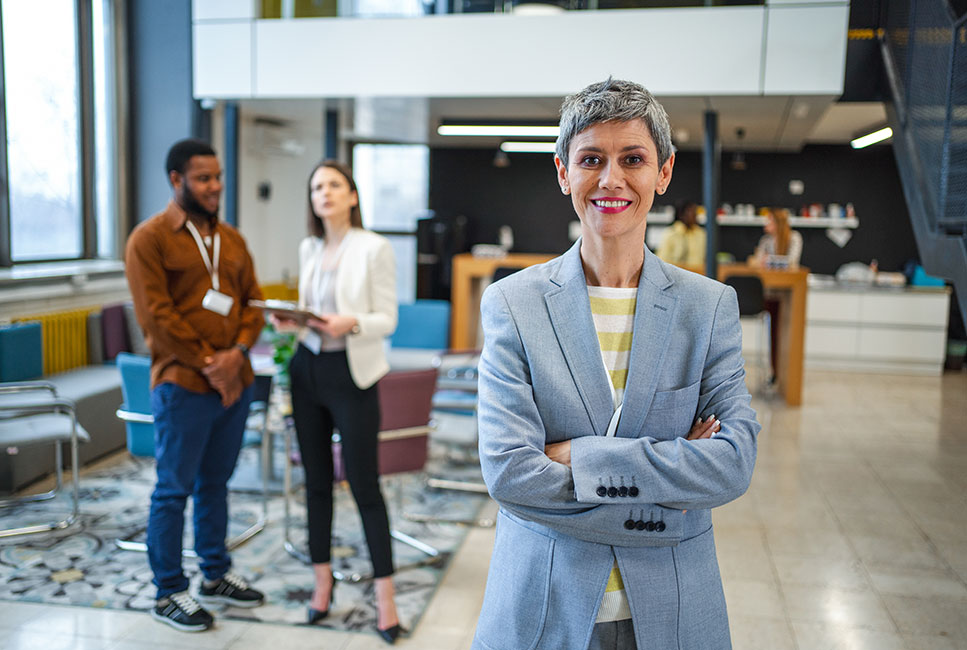 woman standing in front of two colleagues